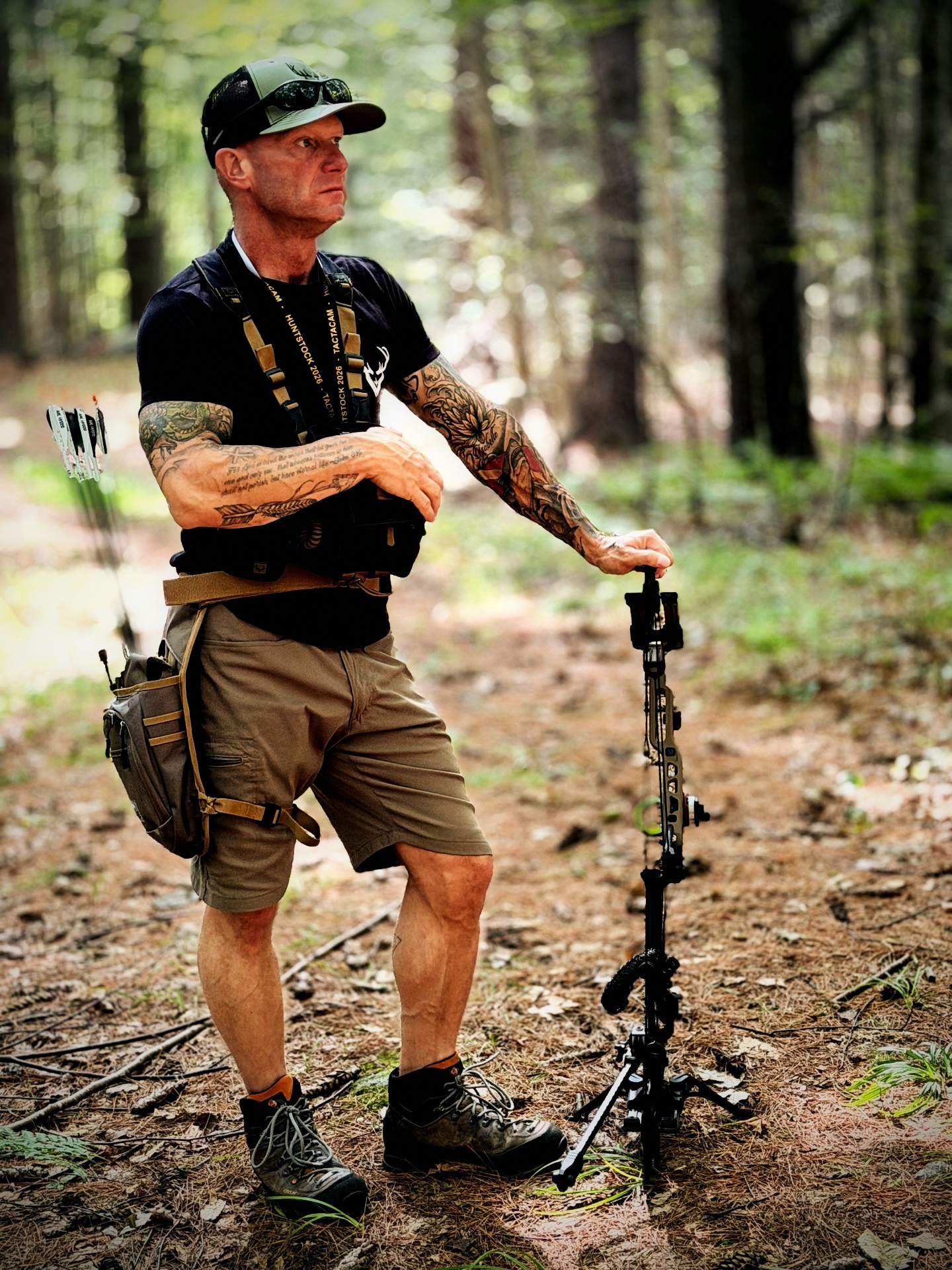 Anthony DelVecchio in the woods with his bow